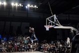 A dynamic shot of a basketball player mid-air during a slam dunk.