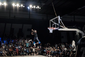 A basketball player making a slam dunk during an intense game