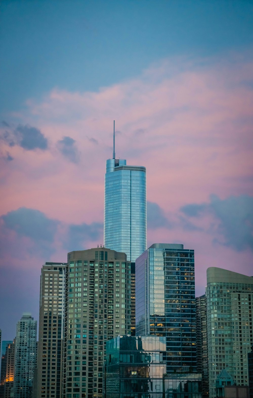 high-rise buildings under blue sky and white clouds