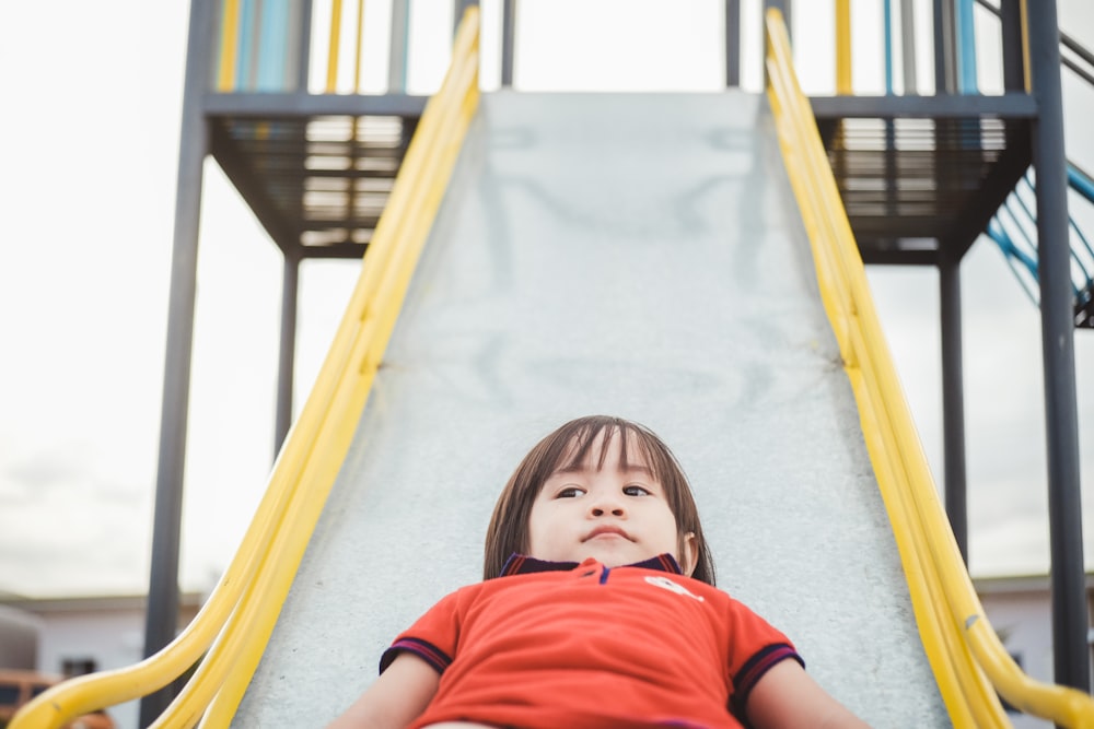 children sliding on slide