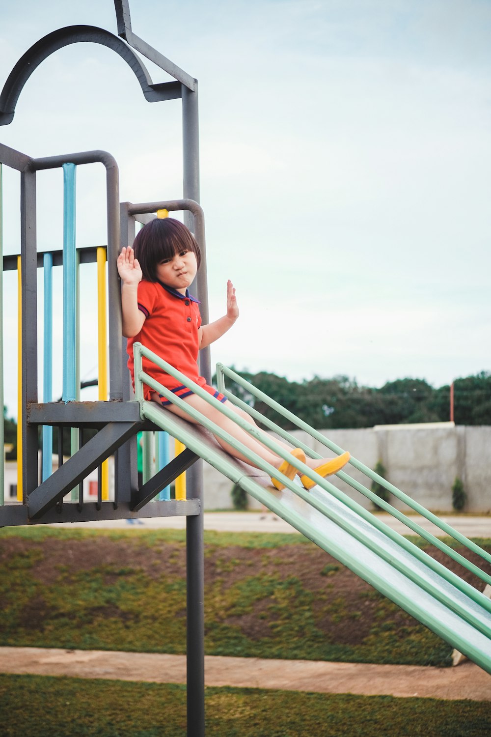 children sitting on slide