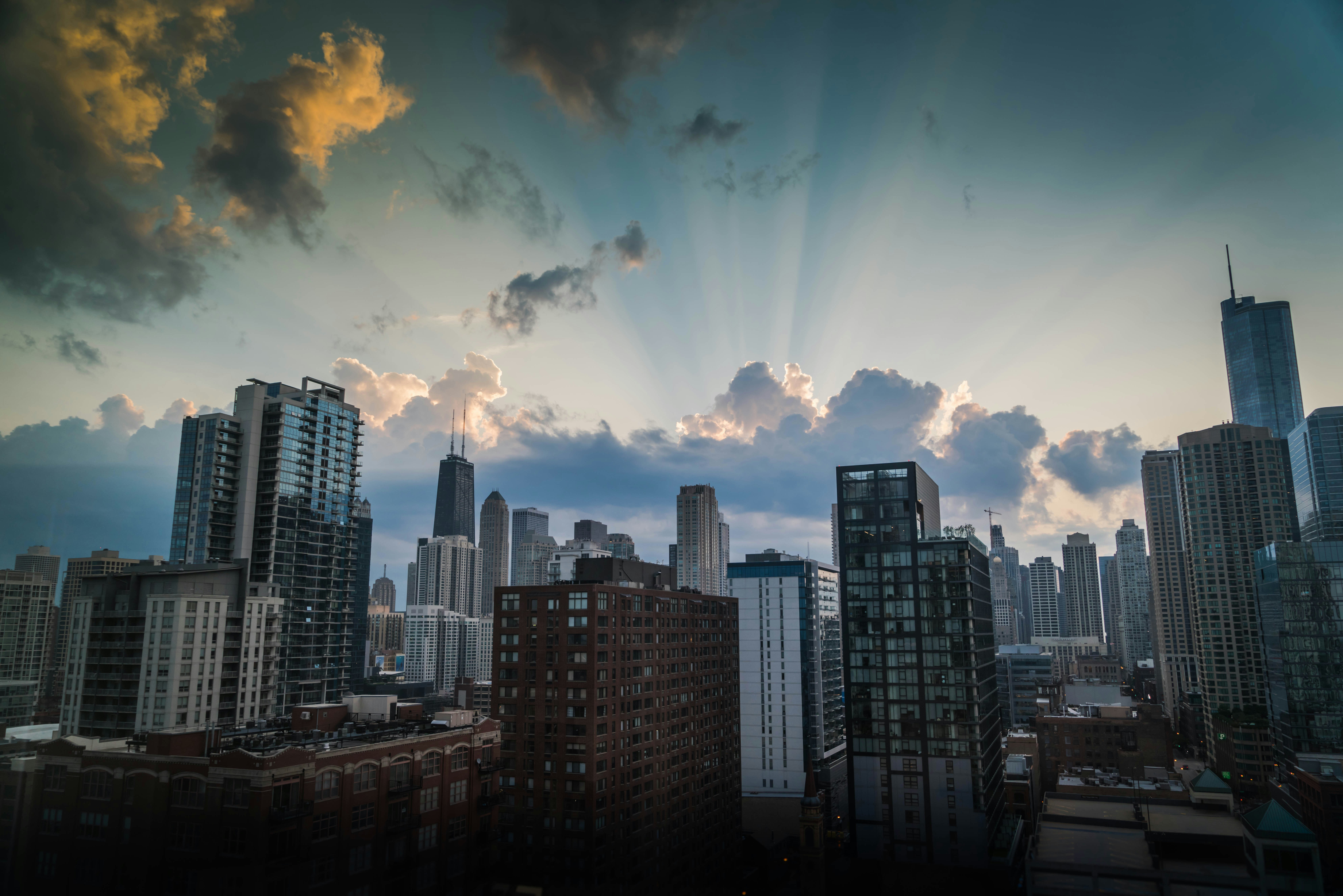 high-rise and mid-rise buildings under cloudy sky