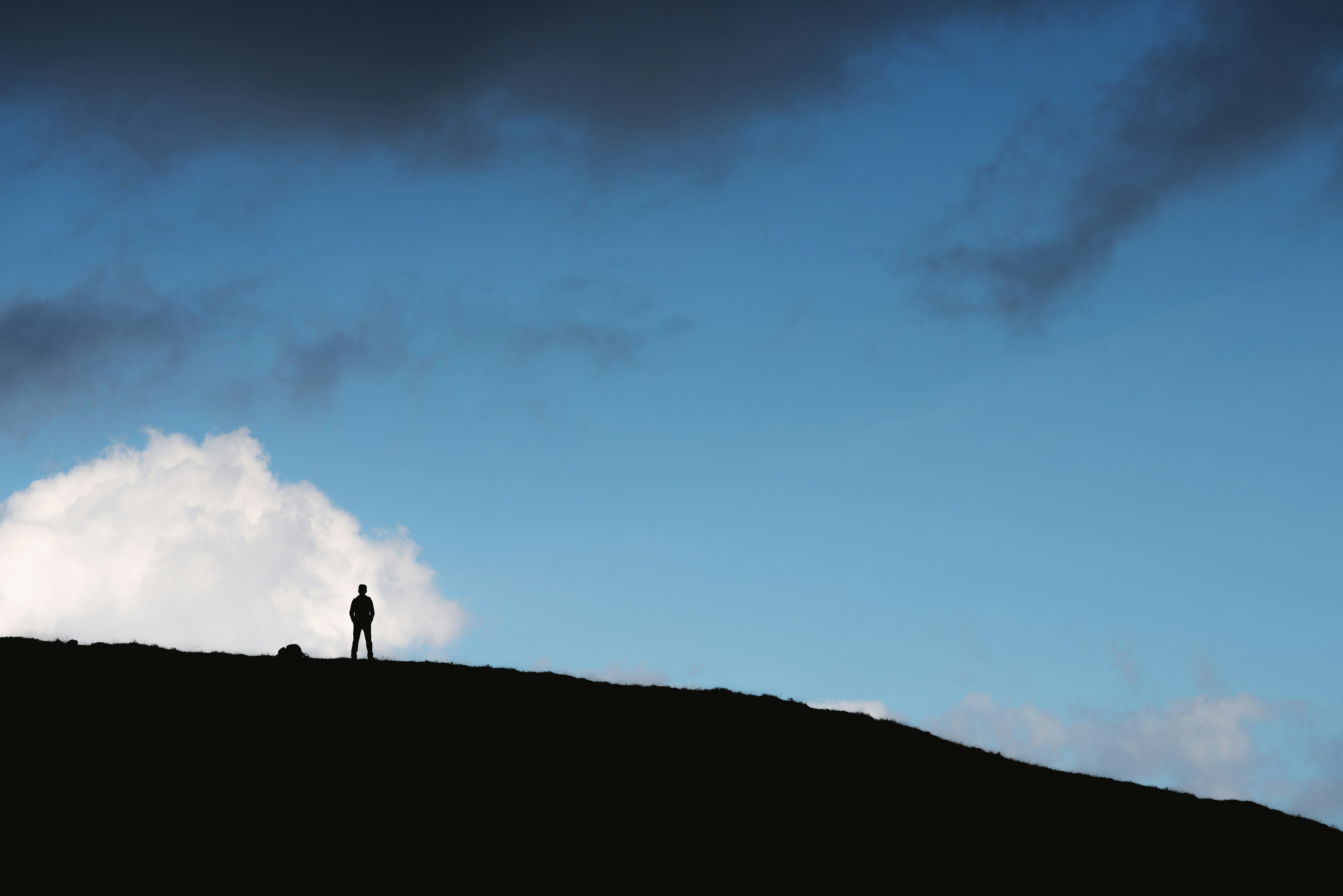 person standing on hill baste teams background