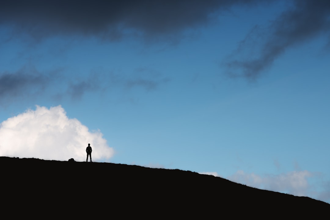 person standing on hill