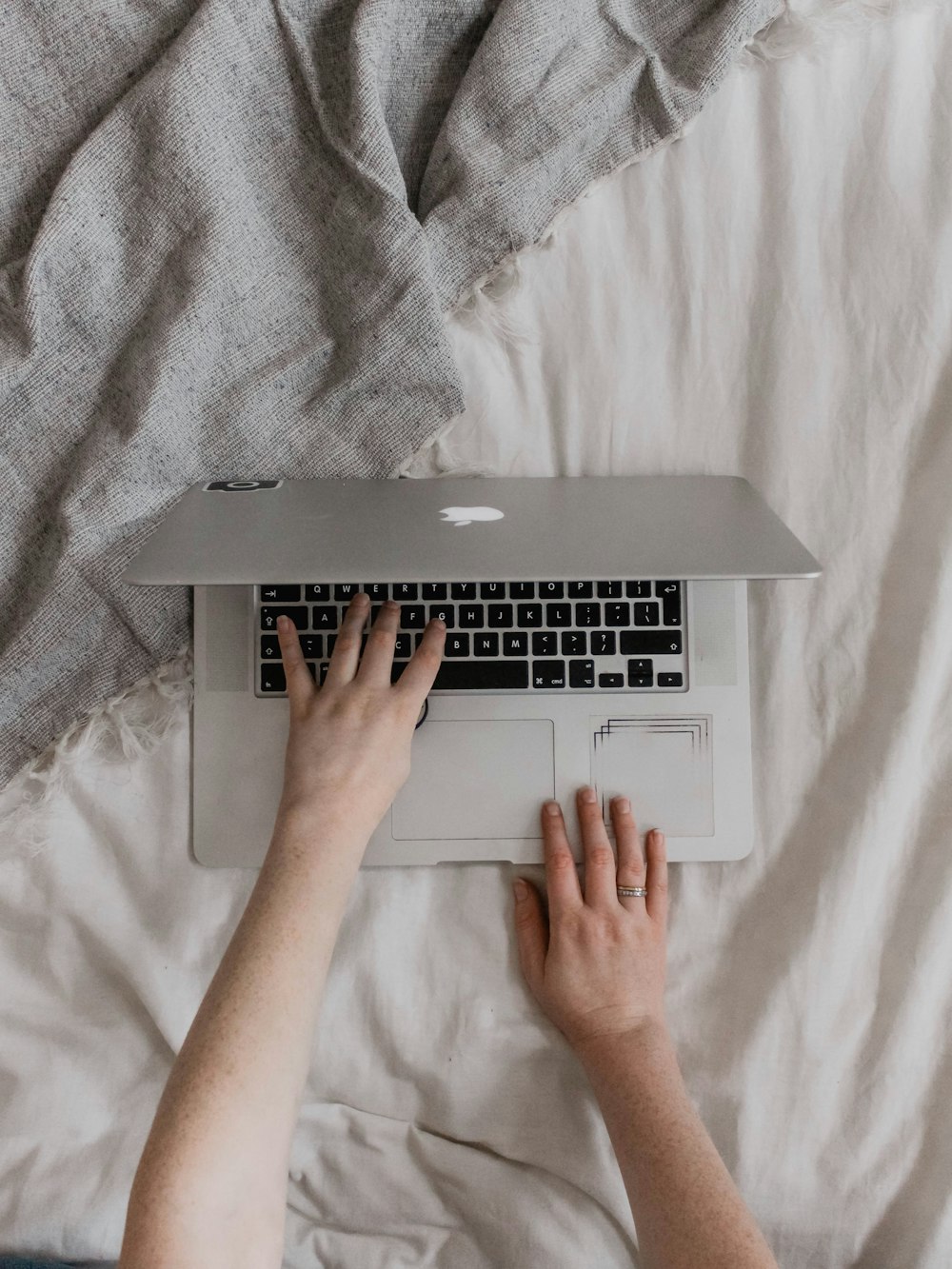 flat lay photography of person using silver MacBook