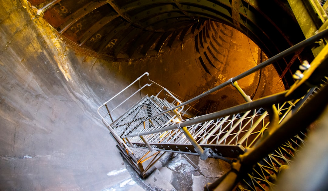 white metal frame on brown concrete tunnel