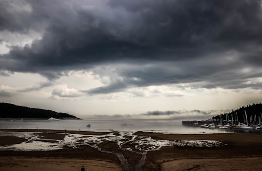 grey rain cloud hovering above the harbor in Tadoussac Canada