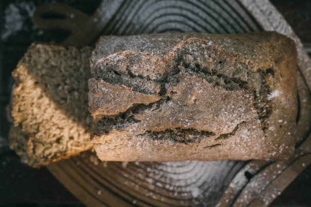 Homemade whole grain bread loaf sliced on a rustic wooden board
