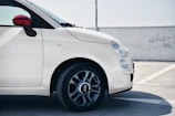 A white compact car with a bright background, highlighting its well-maintained condition.