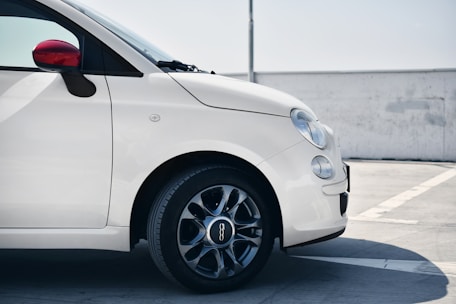 A clean, modern car ready for rental parked in a sunny outdoor location.