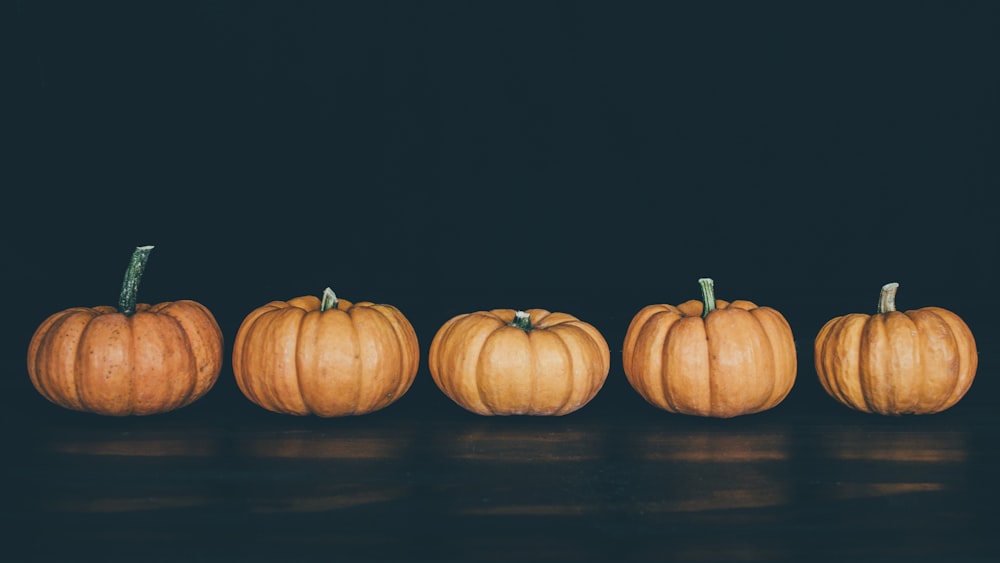 five orange pumpkins