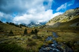 photo of mountains, trees, and clouds