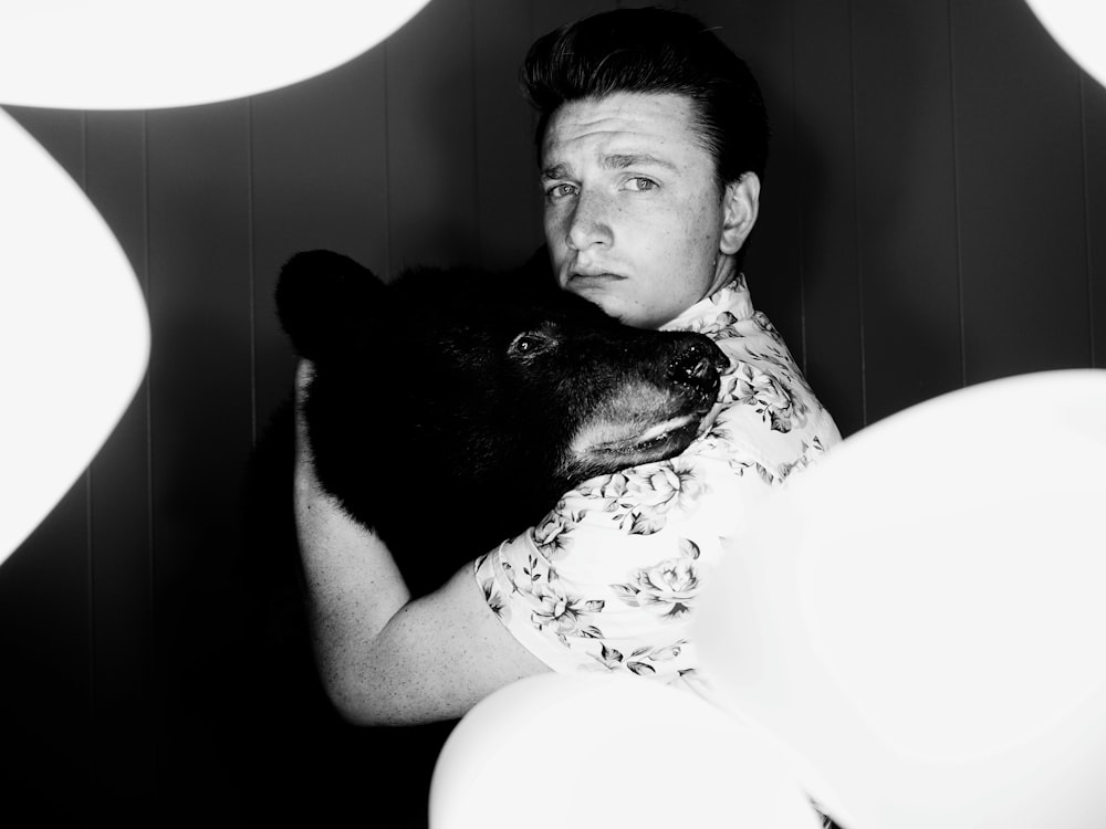 man hugging bear