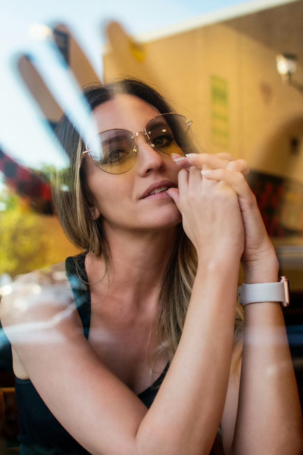 woman placing her hand under her chin