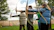 Guests enjoying archery lessons in a lush green forest clearing.