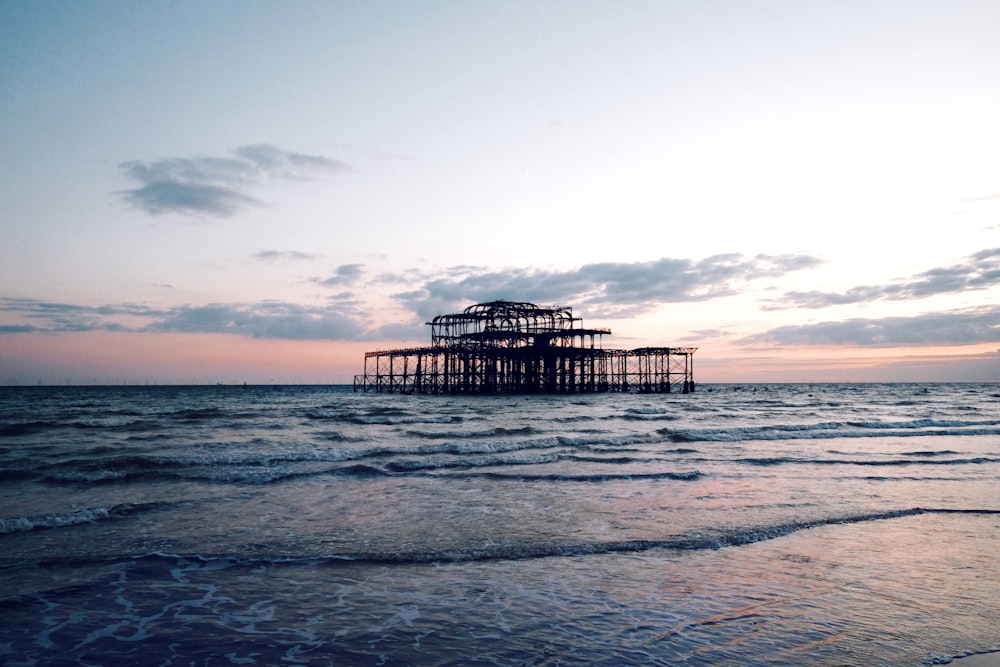 brown metal structure in the middle of sea