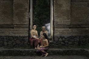 three girl sitting on chair