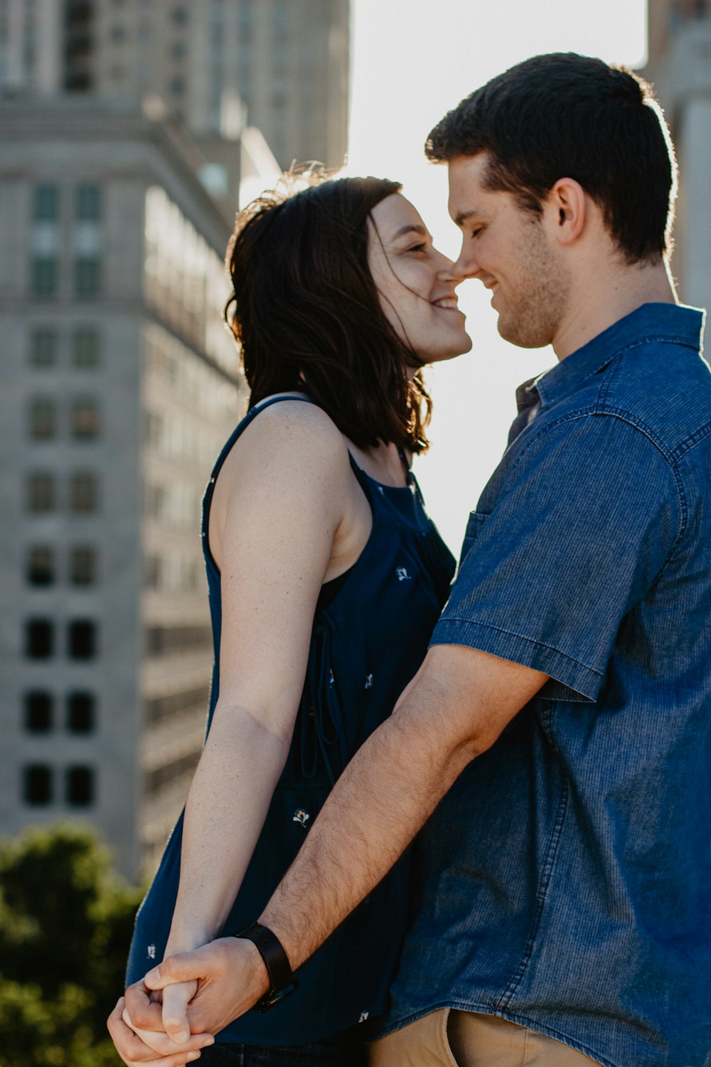 man and woman standing while holding hands during daytime