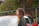 A happy customer standing next to her car at Check-Up Car.