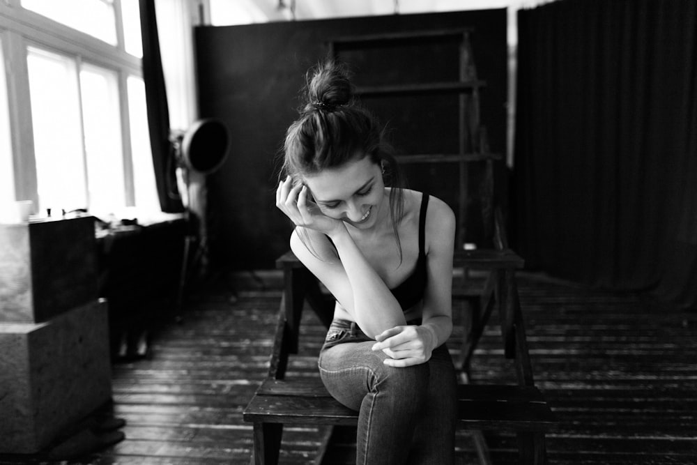 woman in black tank top sitting on the stairs