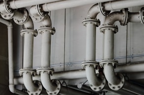 grayscale photography of metal pipes
