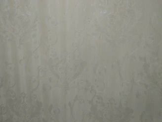 Close-up of colorful textured wallpaper with bold patterns on a dark background