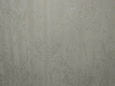 Close-up of colorful textured wallpaper with bold patterns on a dark background