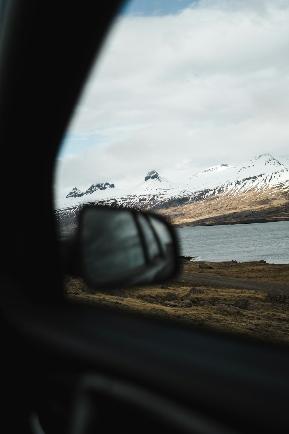 car passing by snow covered mountain