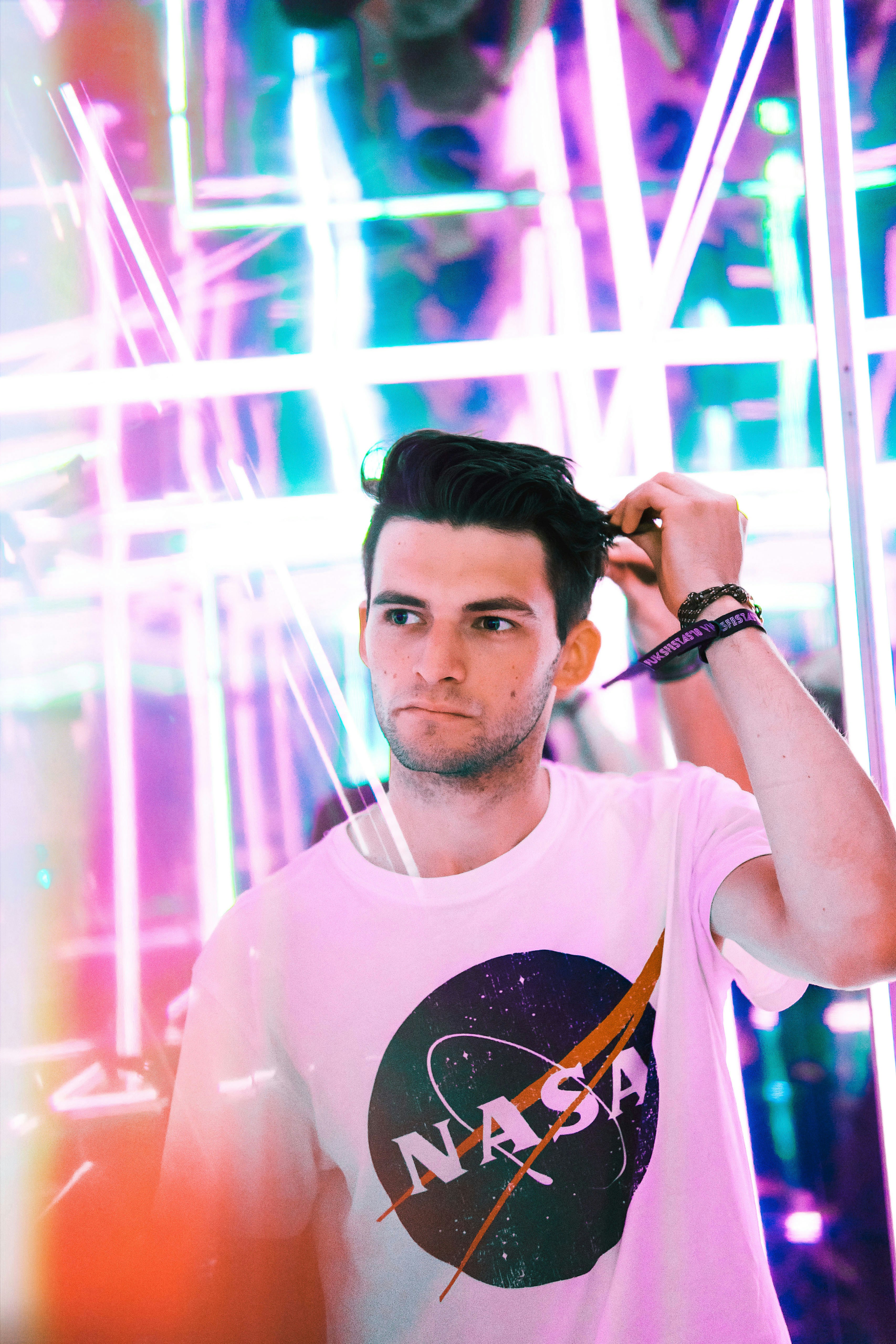 man wearing white NASA crew-neck T-shirt