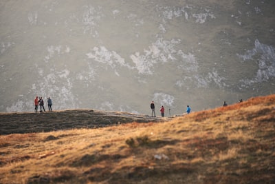 group of people standing on mountain baste zoom background