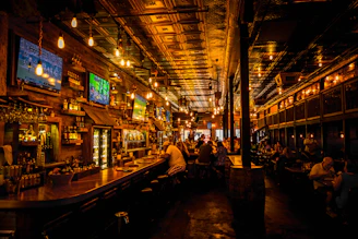 Massive screens showing live Premier League and F1 races with fans cheering in the cozy pub.