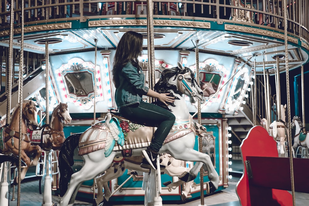 woman riding carousel horse