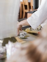 A vibrant sushi chef preparing sushi in a kitchen.