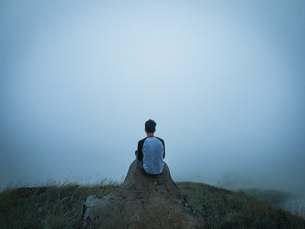 man sitting on a cliff