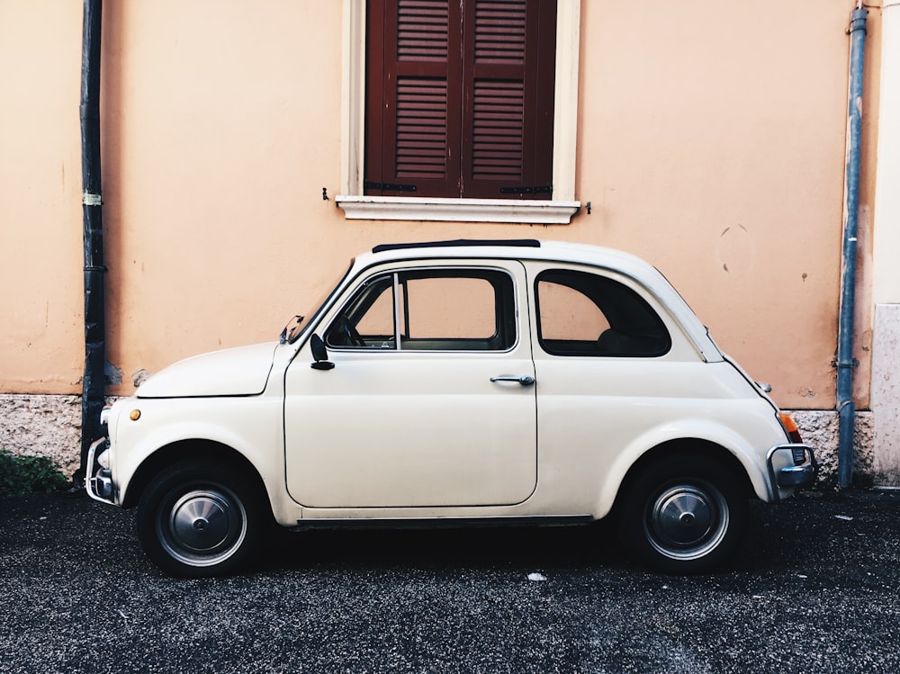 white FIAT 500 3-door hatchback parked near house