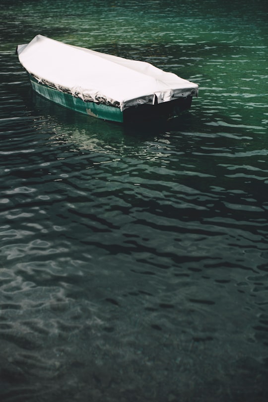 green boat on body of water during daytime in Plansee Austria