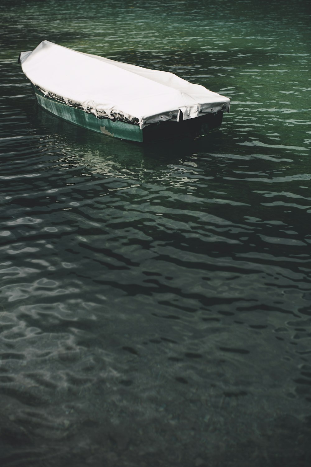 green boat on body of water during daytime