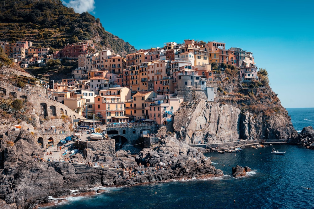 gray concrete buildings on sea cliff during daytime