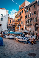 two women leaning on boat under blue sky