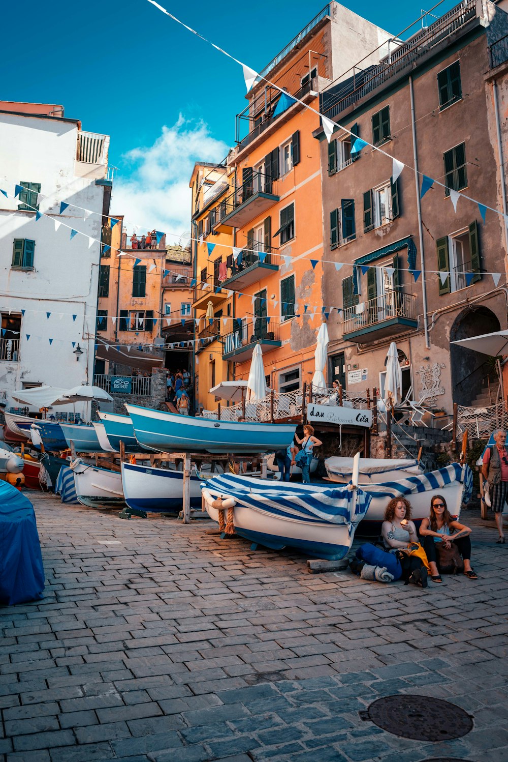 two women leaning on boat under blue sky