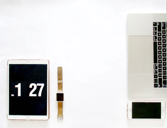 Minimalist arrangement of modern electronics accessories on a clean white surface