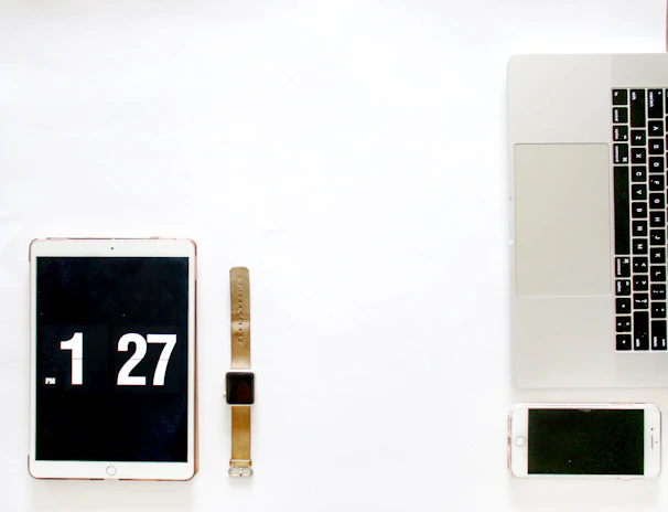 Minimalist arrangement of modern electronics accessories on a clean white surface
