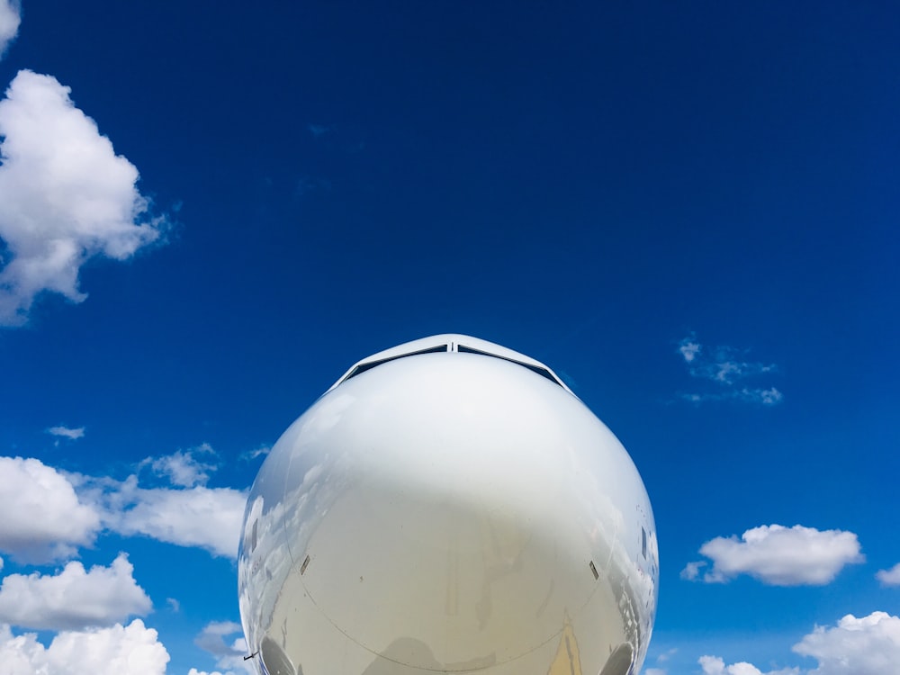 aircraft under blue and white skies