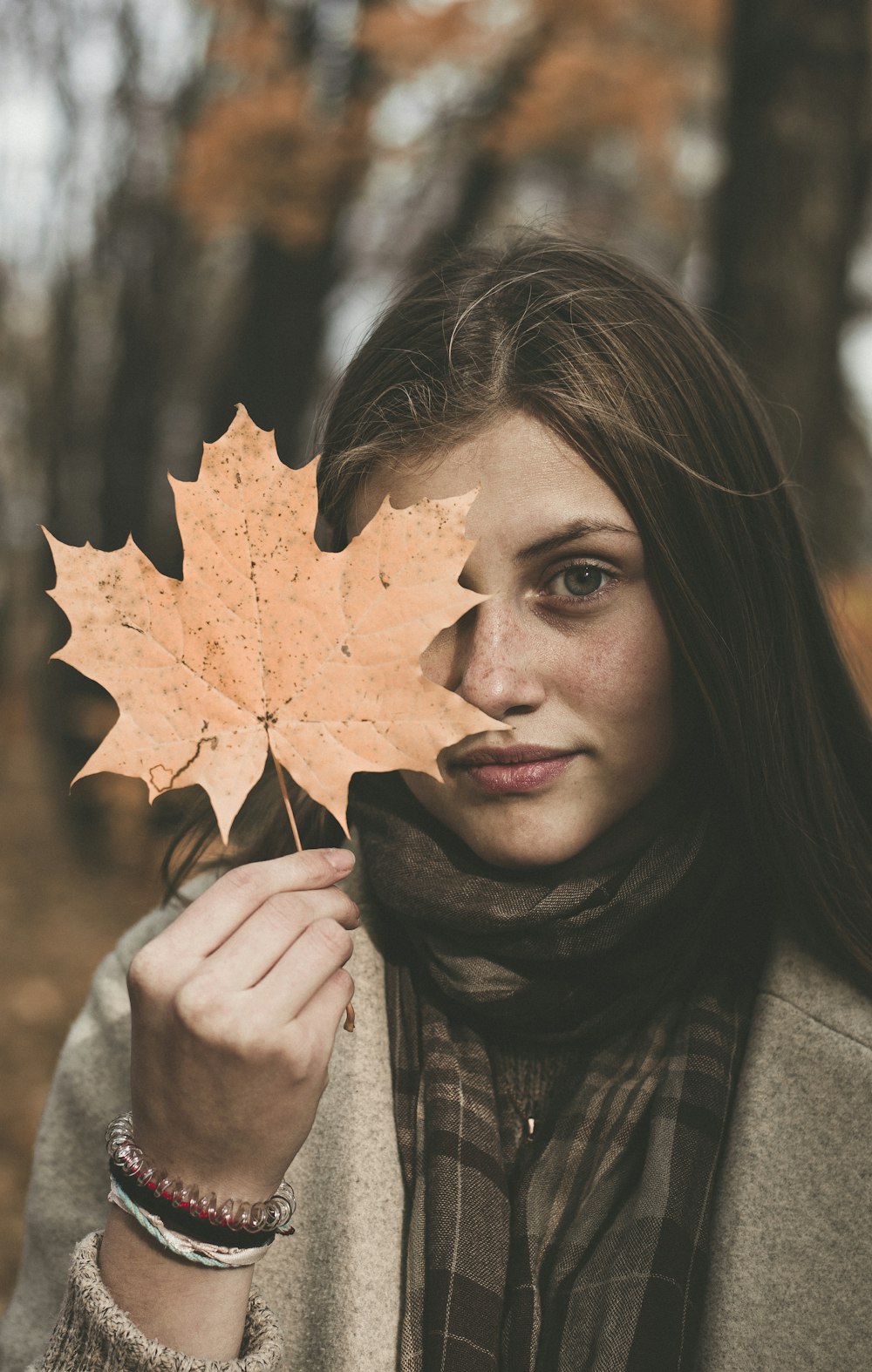 woman holding maple leaf