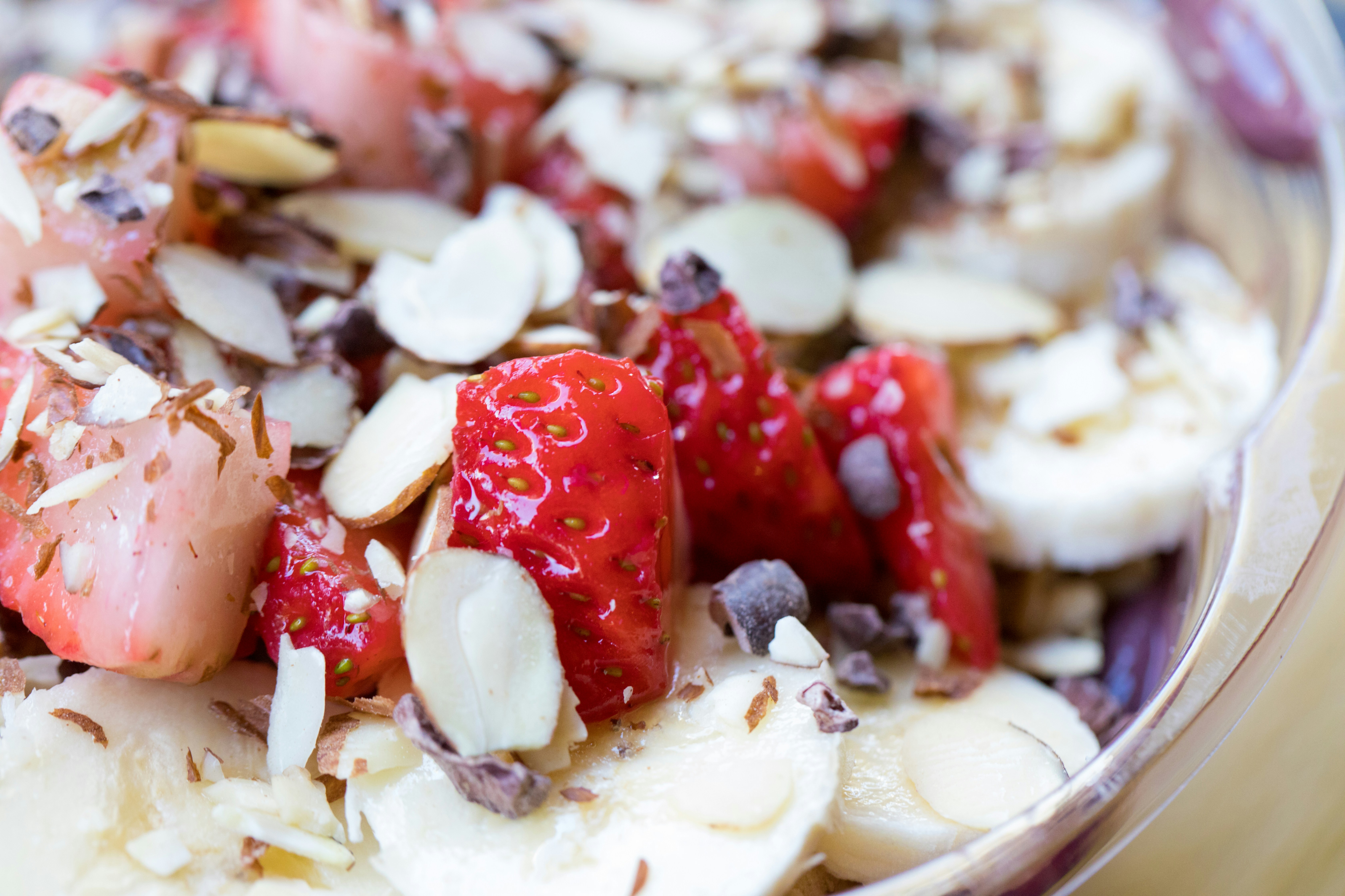 Close-up of yoghurt with strawberries and almonds