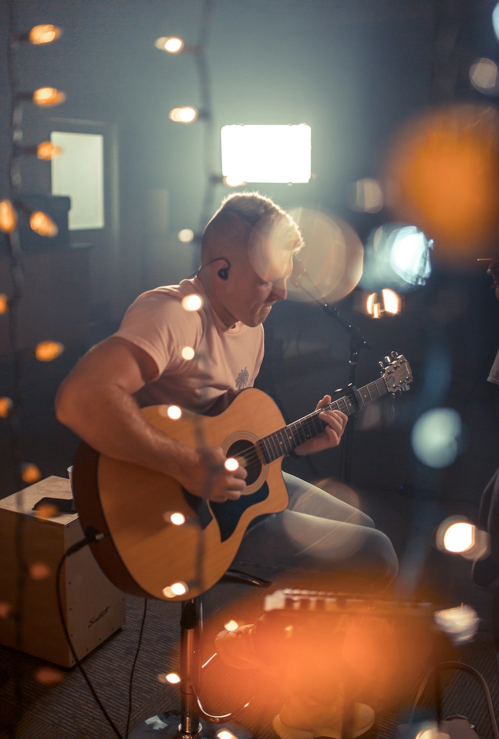 bokeh photography of man playing guitar
