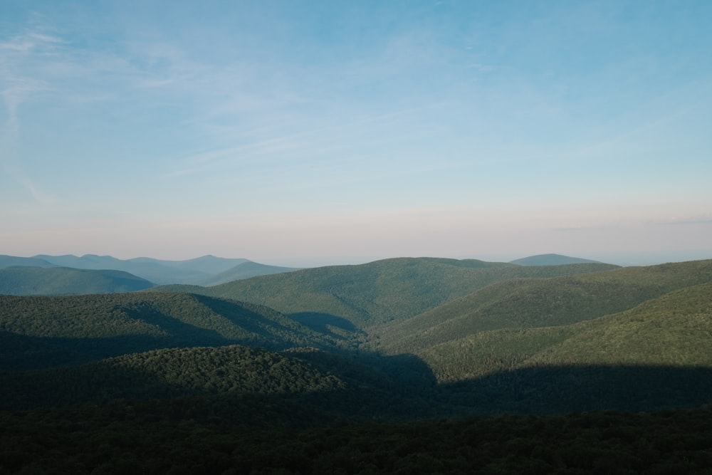 green mountains under white and blue sky during daytime