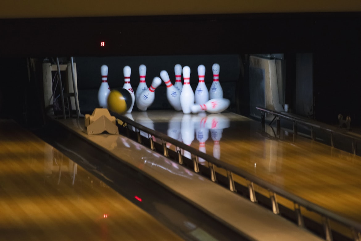 Bowling ball hitting bowling pins in a bowling ally