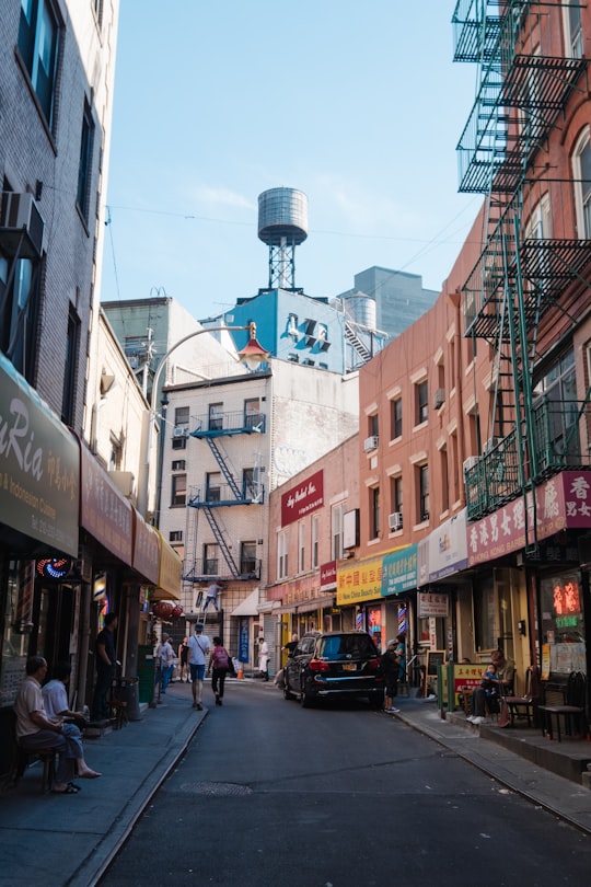 parked vehicles on road between buildings at daytime in Joe's Shanghai United States