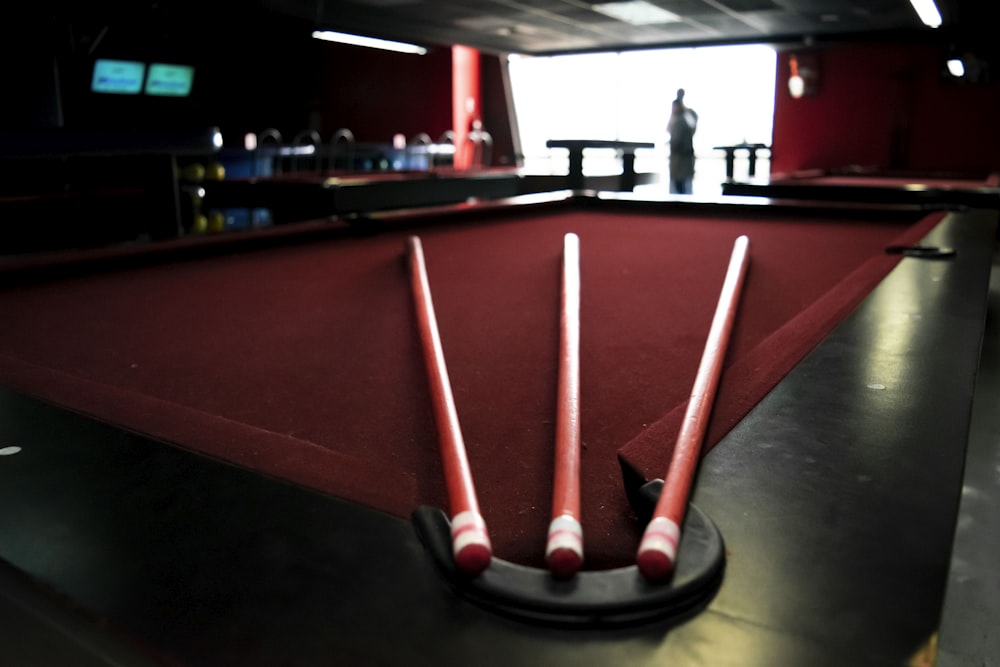 red and black pool table closeup photography